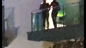 Guys caught making out more than an obstacle balcony