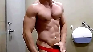 Hung bodybuilder flexing shirtless in the air red horseshit sox briefs zak rogerz